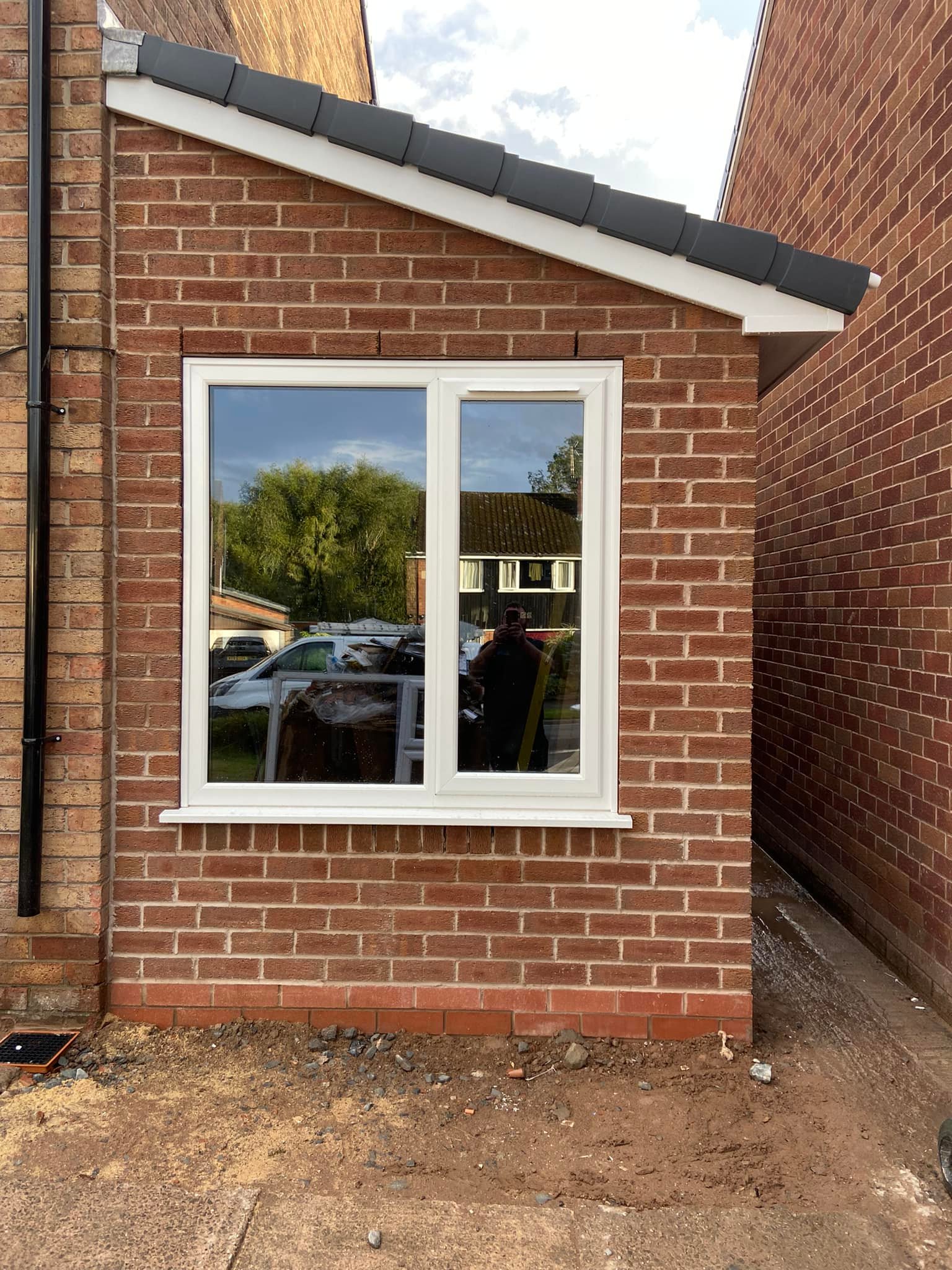 New brick wall and white window on a converted garage